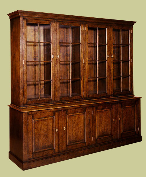 Oak 4-door glazed bookcase with closed cupboards in bottom section.