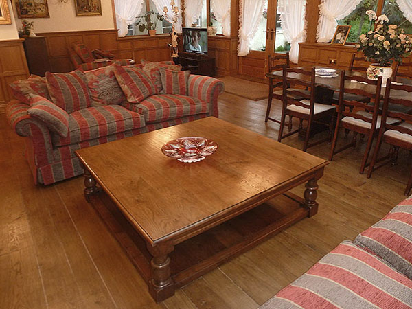 Large square oak potboard coffee table in traditional styled room