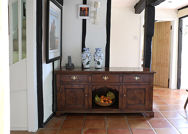 Period style oak dog kennel type dresser base in old beamed cottage