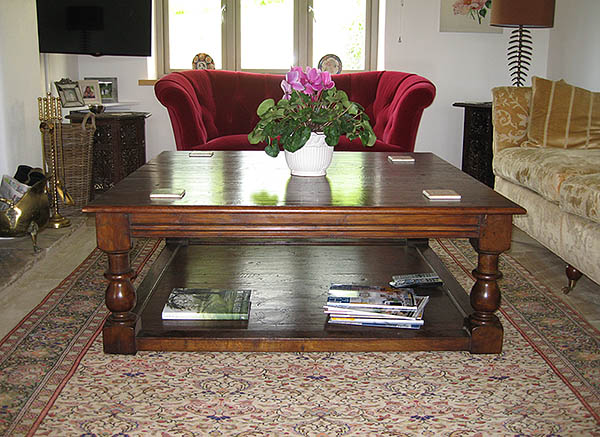 Large oak square potboard coffee table in sitting room of Wiltshire house